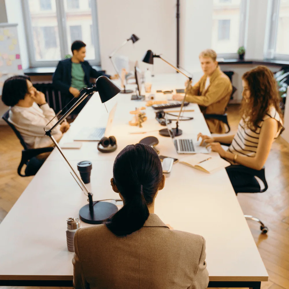 Team working at long desks in an open-plan office